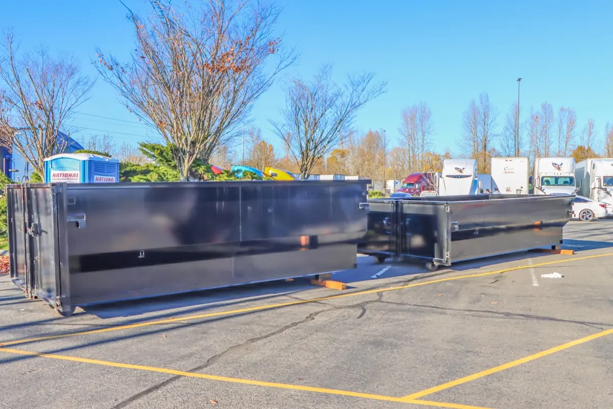 Professional dumpster rental service with roll-off container on residential driveway in Washington